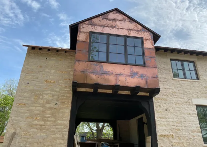 Copper metal panel facade on a stone building for Metal Roof Coating in Rapid City